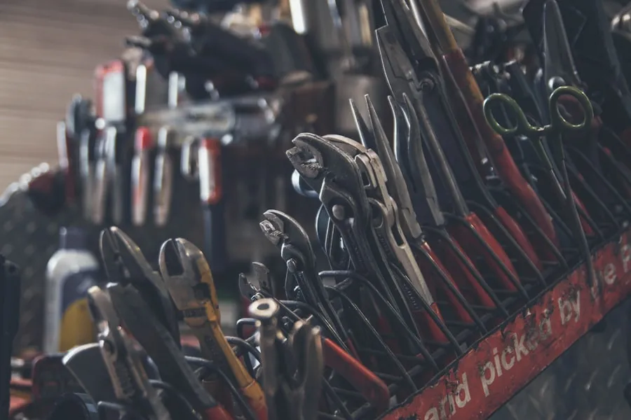 A rack of well-used pliers and hand tools in the workshop